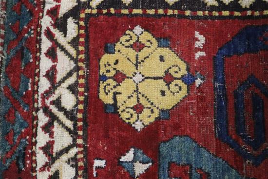 A Caucasian brick red ground rug 208 x 170cm